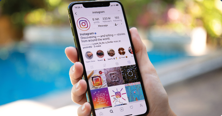 Person checking their phone, wondering can you see who views your Instagram page